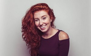 Redheaded woman with type 2C curly hair